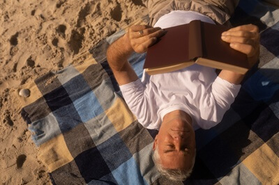 Man Reading on Beach